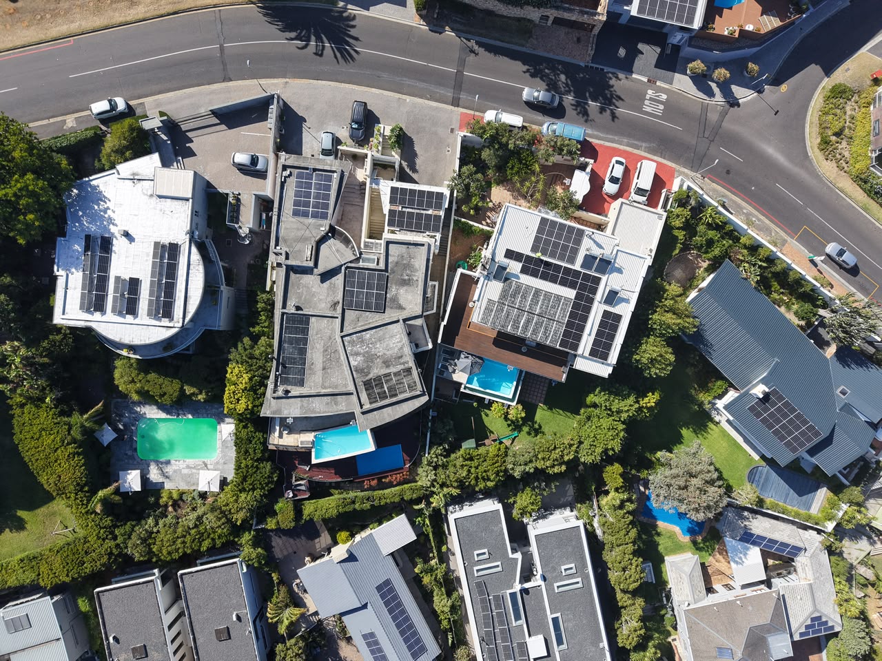 Aerial view of a Cape Town estate with rooftop solar arrays installed by Sun Savings